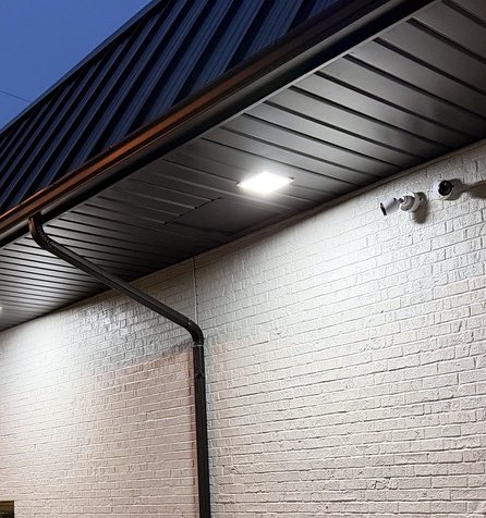 Building exterior at dusk with cameras under the eave